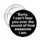 1.25-inch round black enamel pin with white text 'Sorry, I can't hear you'