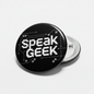 2.25-inch Speak Geek button pin, round black face with white text and circuit pattern