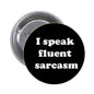 Black round pinback button reading "I speak fluent sarcasm"