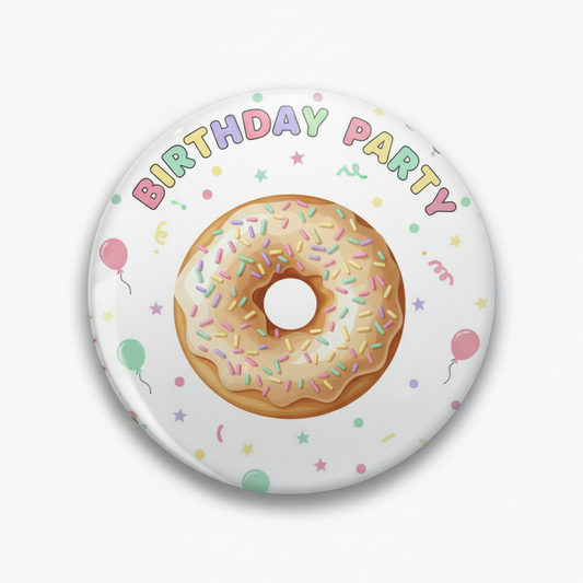 Round donut pinback button, white with “Birthday Party” text and colorful sprinkles