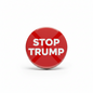 Red round pinback button with white “STOP TRUMP” text