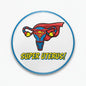 Circular uterus pinback button with blue rim, superhero graphic, and “SUPER UTERUS!” text