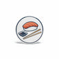 Circular soy sauce sushi pinback button with salmon nigiri, soy dish, and chopsticks