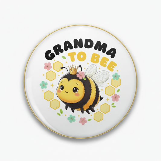Round pinback button with cute bee graphic and text “GRANDMA TO BEE”