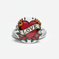 Tattoo-style heart pinback with red heart, LOVE ribbon, flames, and roses, round