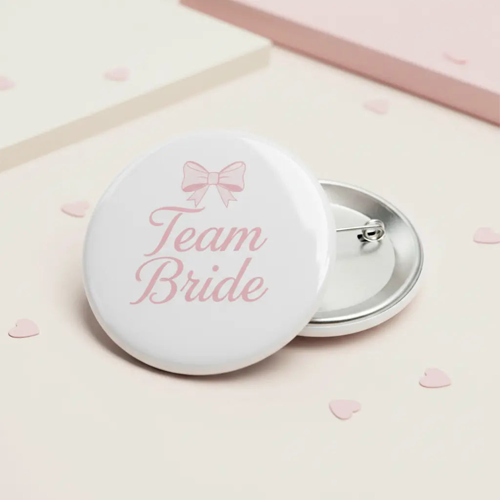 Round pinback button: pink bow, 'Team Bride' text