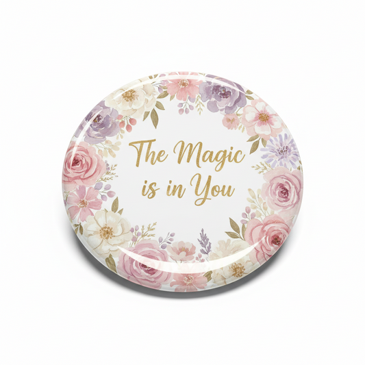 Round 2.25-inch pinback button with floral wreath and “The Magic is in You” text
