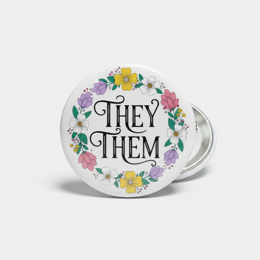 Pride pinback button with floral wreath and 'THEY THEM' lettering