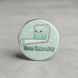 Round enamel-style pinback button with cute toothbrush bear and text “Three Times a Day”