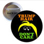 1.25-inch round pinback button with black background, TRUMP HAIR and DON'T CARE text