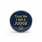2.25-inch judge pinback button with navy face, gold text 'Trust Me I Am a Judge' and scales