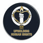 Round navy Amnesty pinback button with candle emblem and gold 'UPHOLDING HUMAN RIGHTS' text
