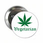 A round pin-back button shown from both front and back. The front has a white face with a green cannabis leaf above the word 'Vegetarian' in green gothic-style lettering.