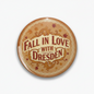 Round tan pinback button with ornate 'Fall in Love with Dresden' lettering and border