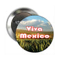 Round Viva Mexico pinback button with grass field, sky, and red Viva Mexico text