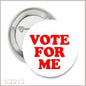 Round pinback button with red 'VOTE FOR ME' text on white, silver metal edge
