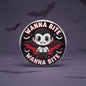 2.25-inch vampire pinback button, circular badge with cartoon bat-winged character and 'Wanna Bite'.