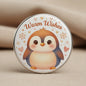 Round penguin pinback button with 'Warm Wishes' and winter hearts and snowflakes
