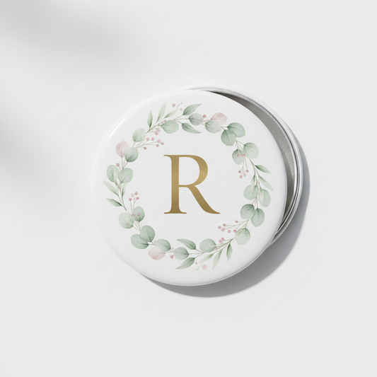2.25-inch pinback button with gold letter R and green foliage wreath design