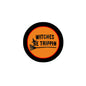 2.25-inch round pinback button with black border, orange center, "WITCHES BE TRIPPIN".