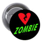 Zombie pinback button with black face, red heart, and green “ZOMBIE” text