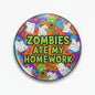 Pinback button with colorful zombie artwork and text 'Zombies Ate My Homework'